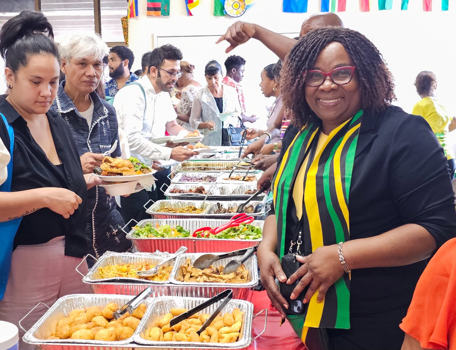 Members and guests of Alhambra Seventh-day Adventist Church sharing dishes from around the world at a First Saturday potluck
